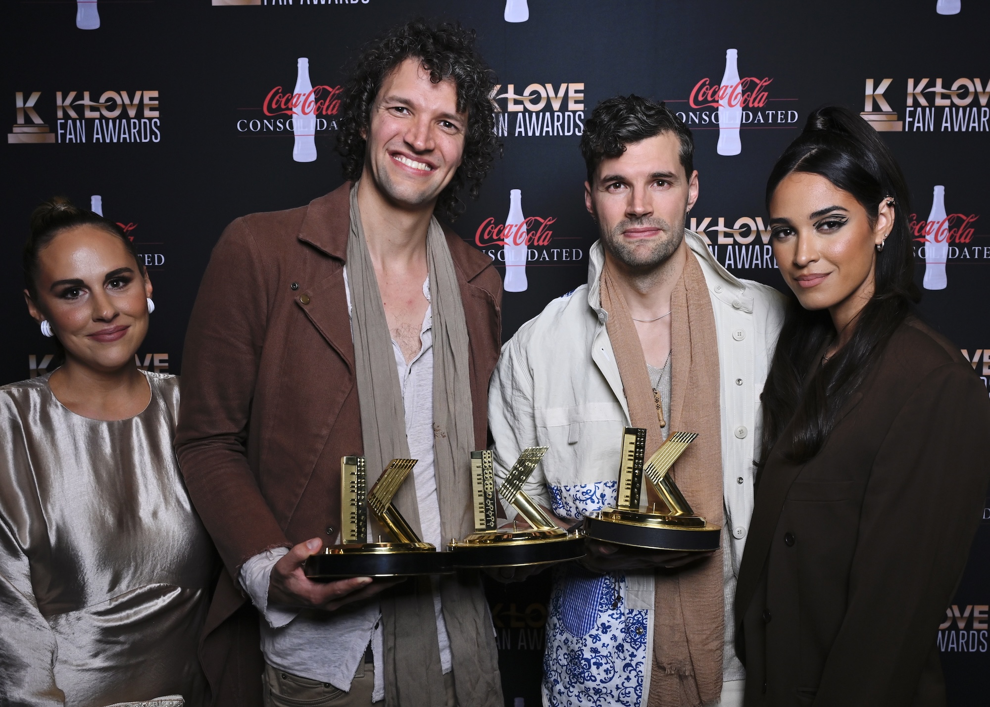 for KING and COUNTRY holding three K-LOVE Fan Awards next to their wives