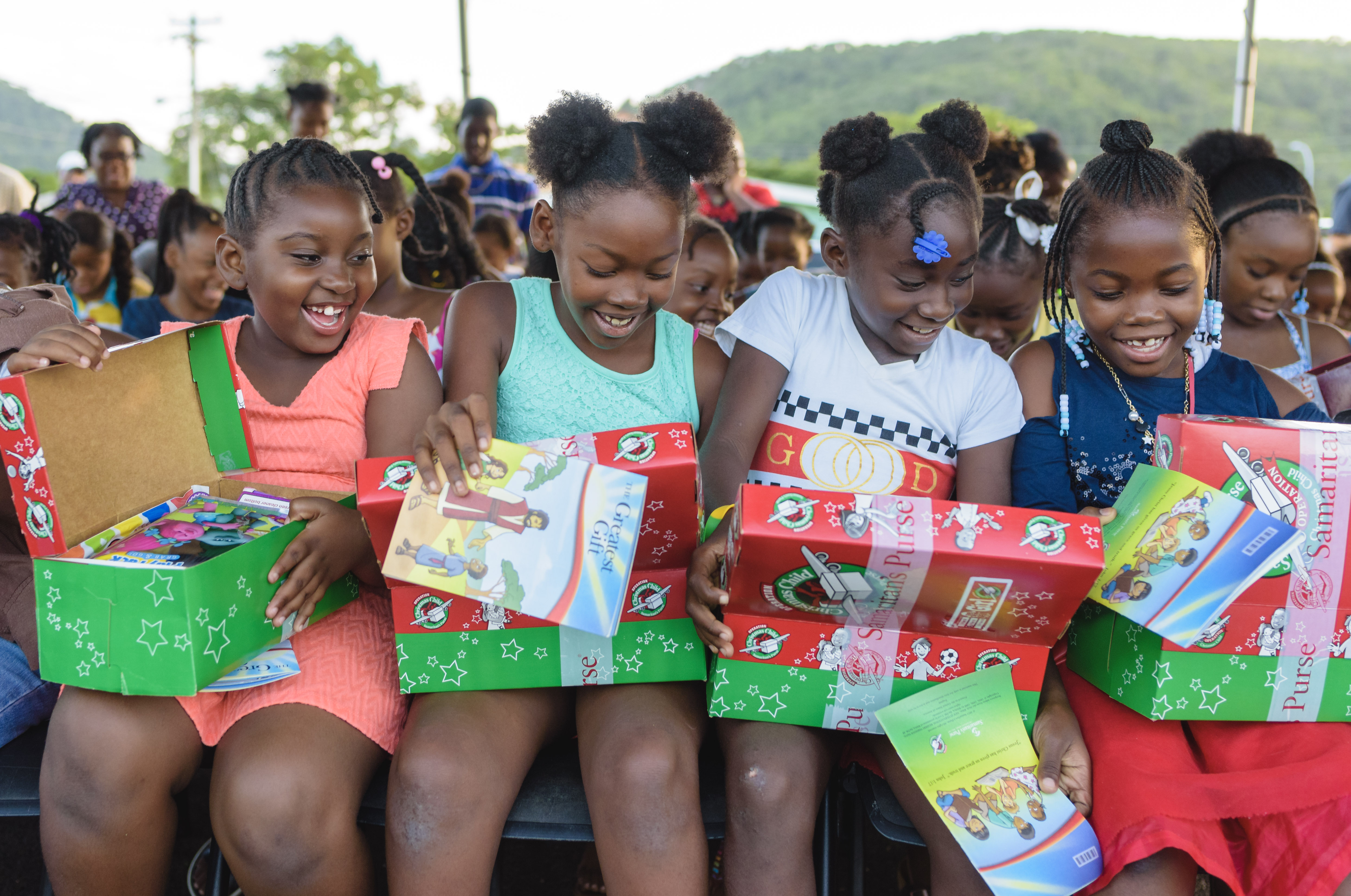 SP OCC Girls in Antigua dig into their shoebox gifts with excitement