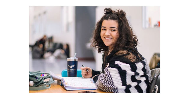 Young girl at school smiling at camera