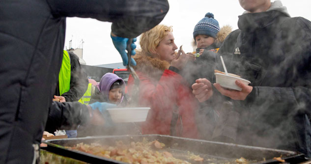 Refugee mom feeds baby sausage