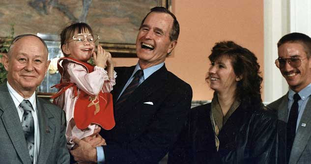 President George H.W. Bush holds Jessica McClure in the Roosevelt Room at the White House (1989-07-19)