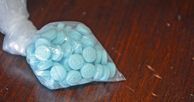 Bag of blue pills designed to look like Rx seized by police in a drug bust.