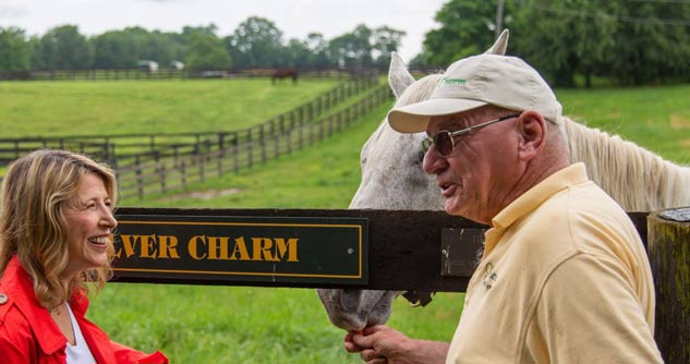 Michael Blowen of Old Friends Farm feeds Silver Charm a carrot