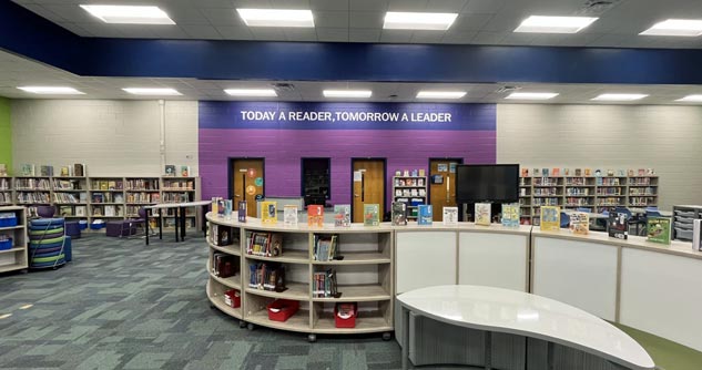 New library built and stocked, "Today a Reader, Tomorrow a Leader" on wall