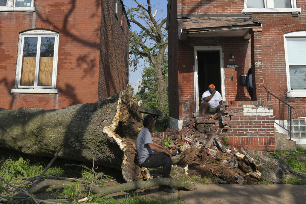 People survey damage after a severe storm moved through Friday, May 16, 2025, in St. Louis.