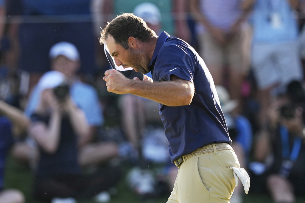 Scottie Scheffler celebrates after winning the PGA Championship golf tournament at the Quail Hollow Club