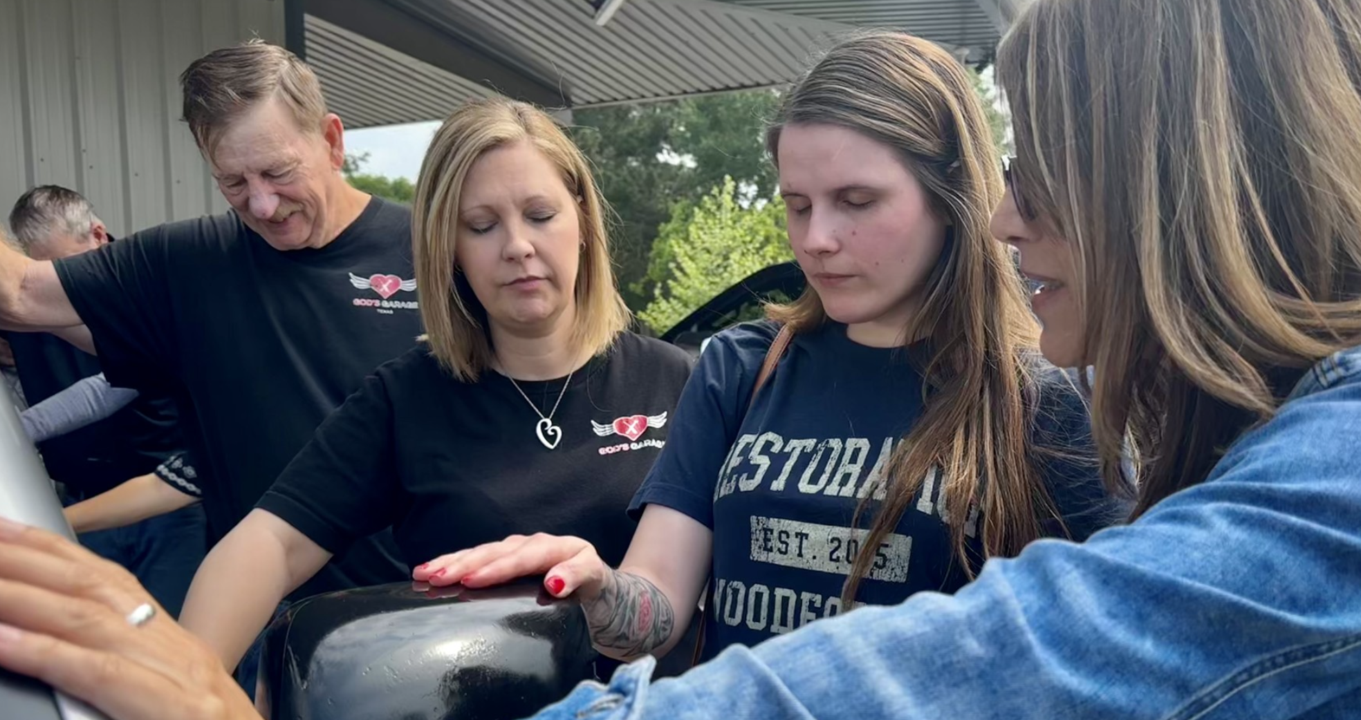 Volunteers and a car recipient