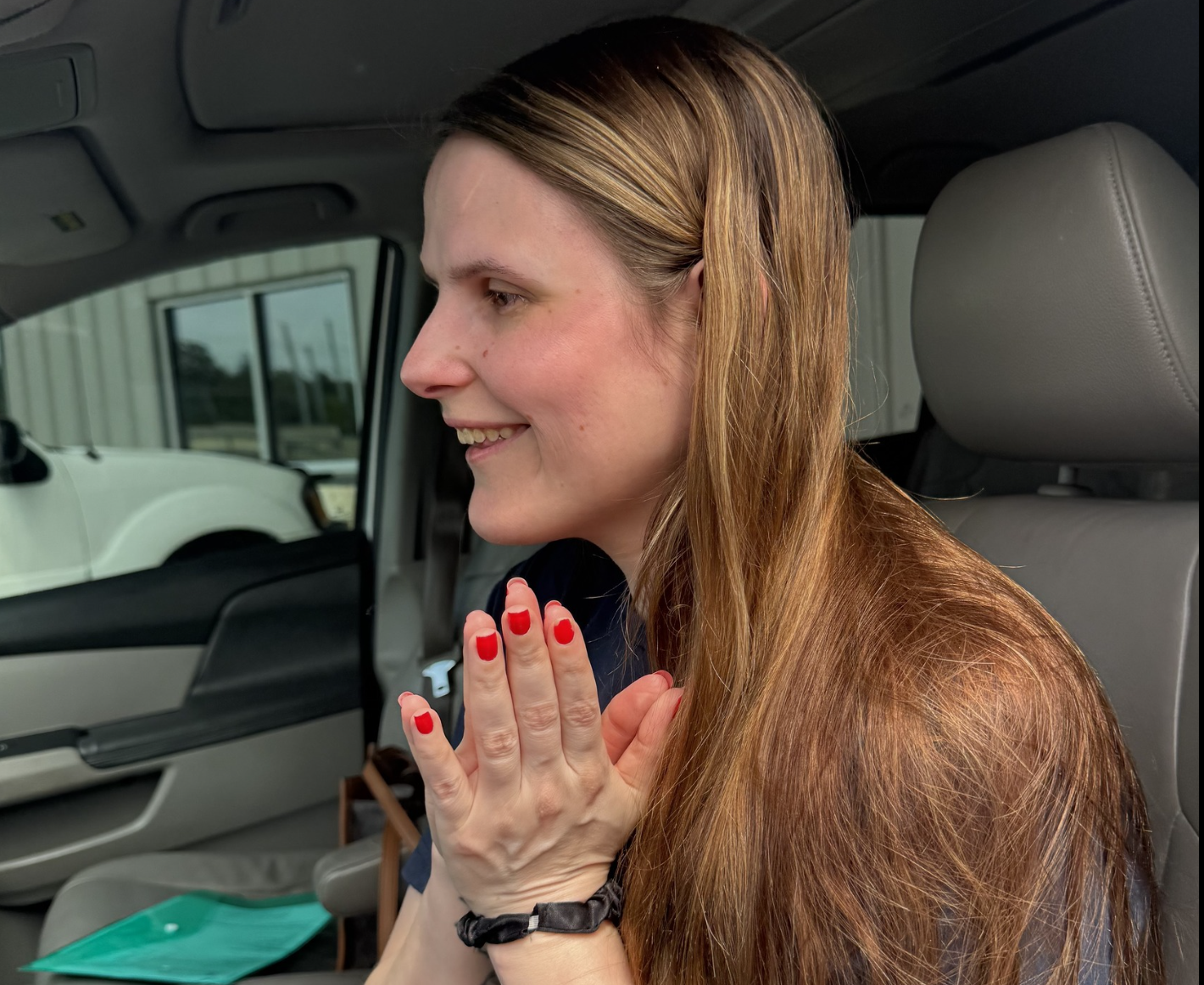 Woman smiling inside of a car