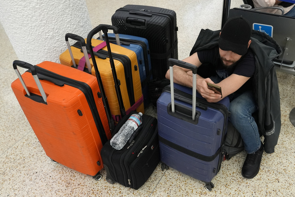 Pasha Pidlubniak waits for a domestic flight at the international airport ahead of the Memorial Day holiday, in Miami