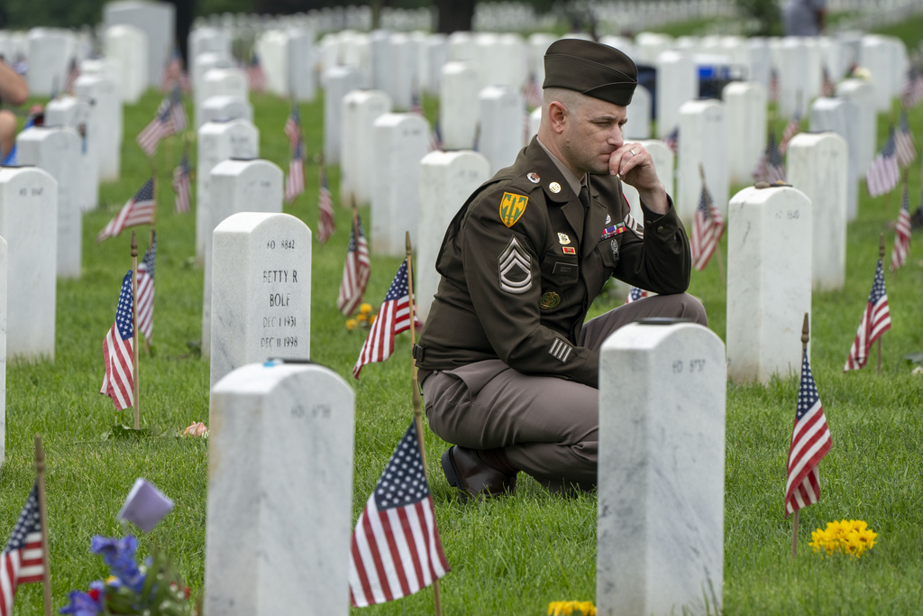 A member of the Army visits Section 60 of Arlington National Cemetery, in Arlington, Va.