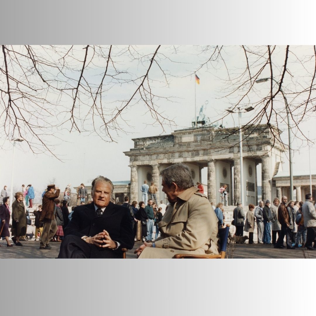 Billy Graham sits for an interview in front of the Brandenburg Gate in 1990, three months after the fall of the Berlin Wall.