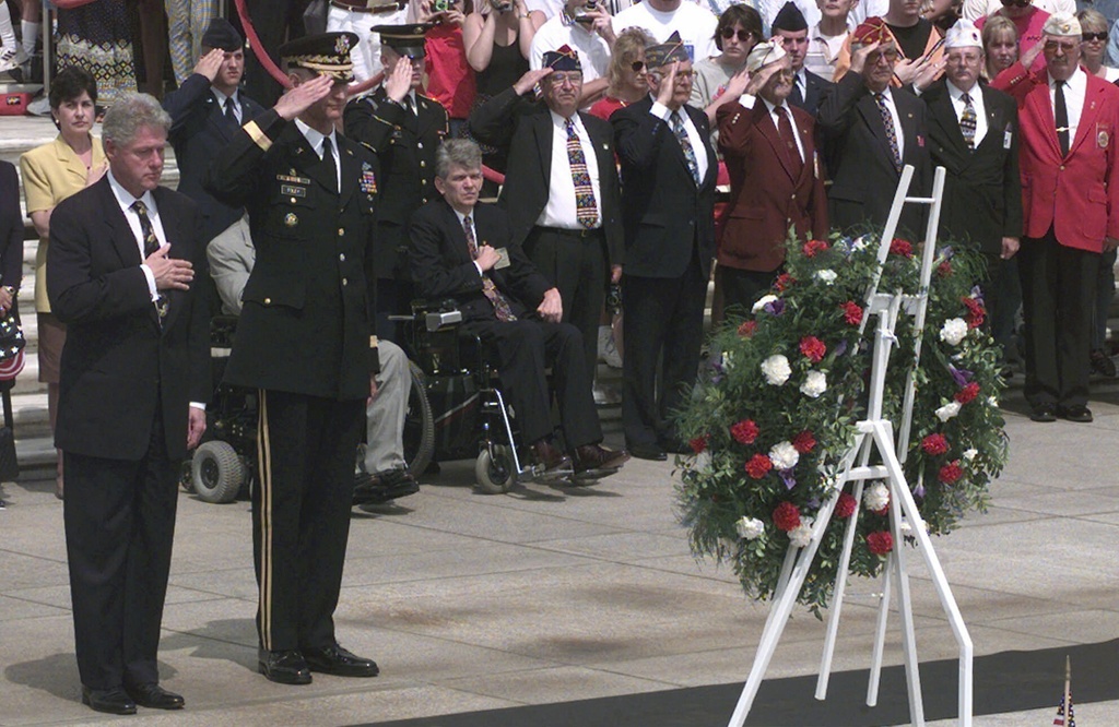 President Clinton stands with his hand over his heart during the playing of "Taps" at the Tomb of the Unknowns during Memorial Day ceremonies at Arlington National Cemetery