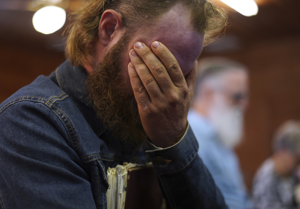 saac Green, 34, covers his eyes while praying before a Sacred Harp singing event at Holly Springs Primitive Baptist Church