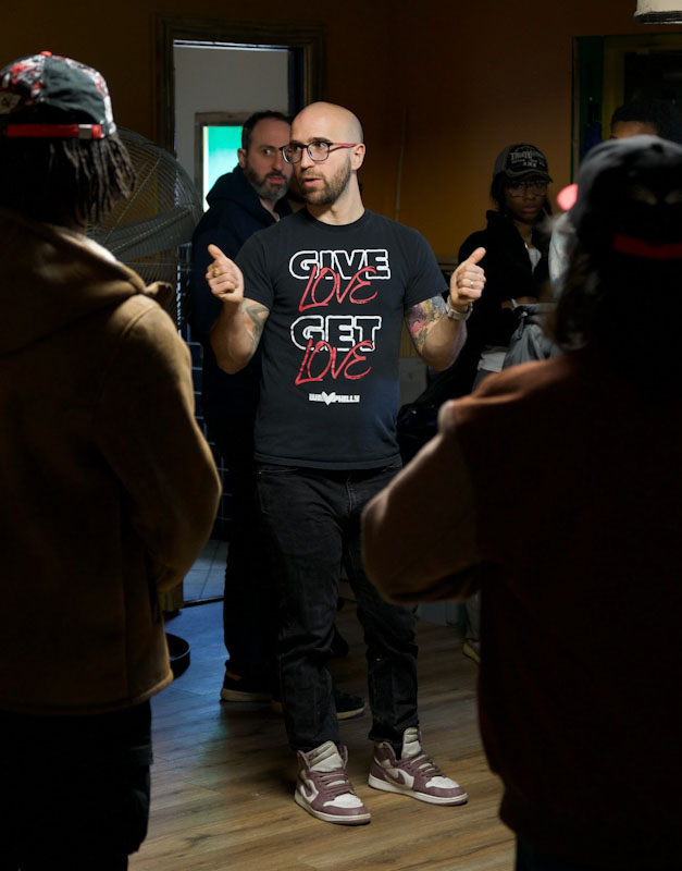 Carlos Aponte, founder and executive director of We Love Philly, giving two thumbs up as he speaks to a crowd.