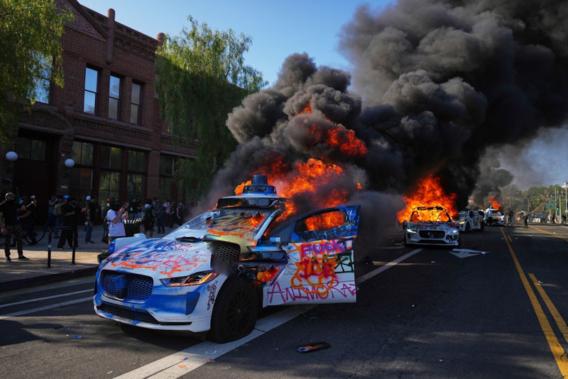 Multiple Waymo taxis burn near the Metropolitan Detention Center of downtown Los Angeles