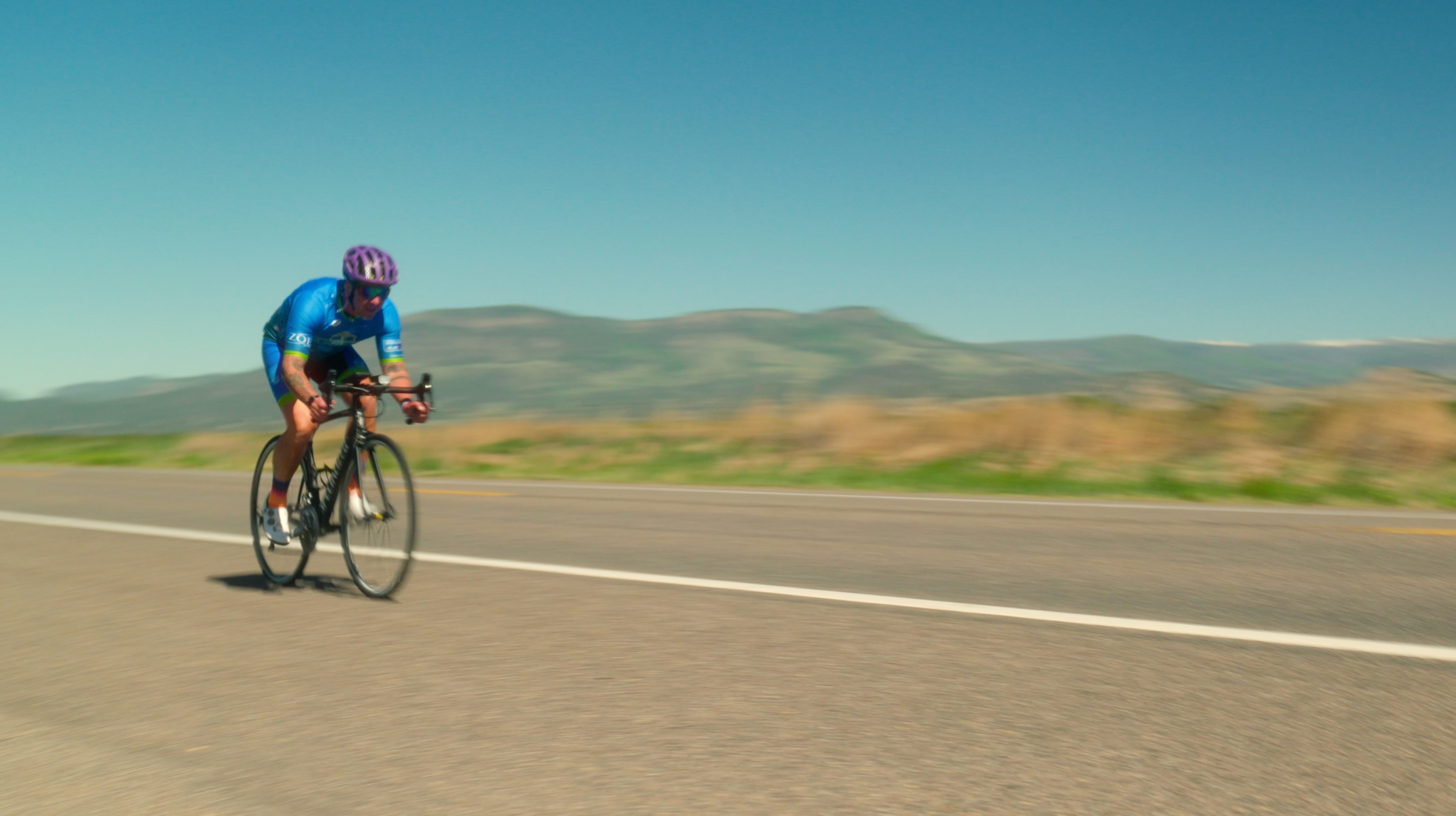 ZOE racer Kevin Quinter speeding down the road after passing over the Rockies