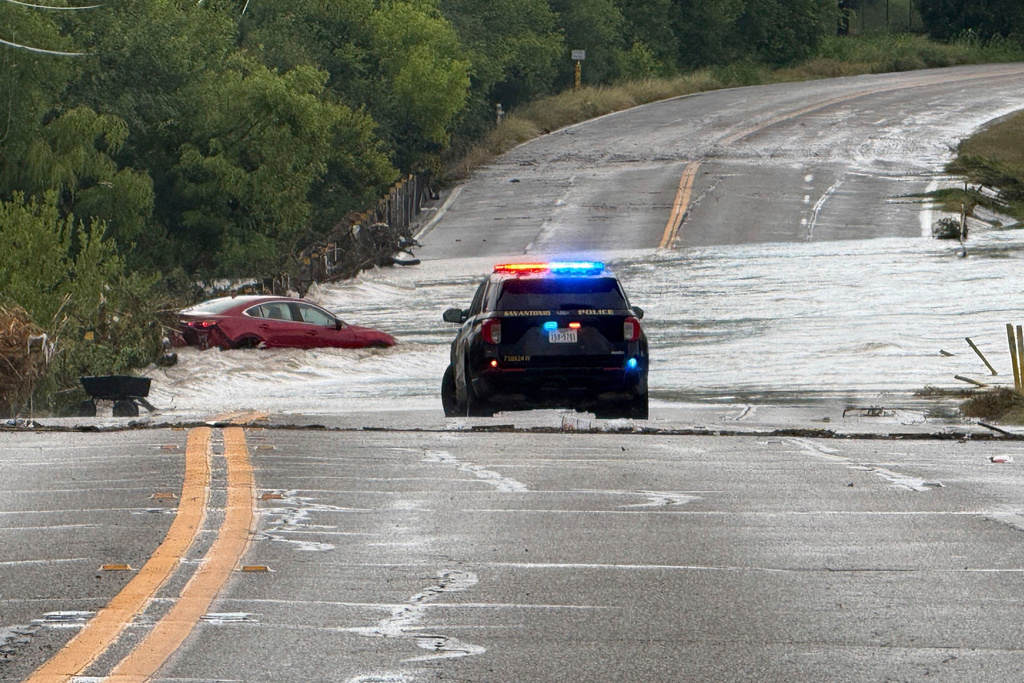 A police vehicle blocks a flooded roadway in San Antonio