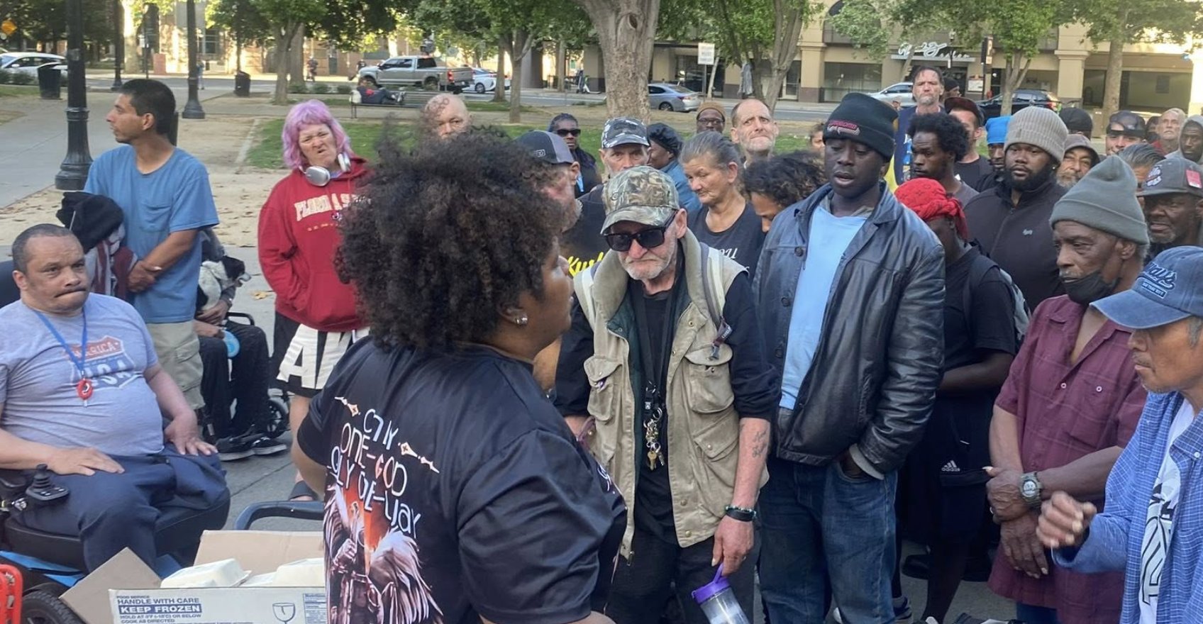 Woman speaking to crowd on the street