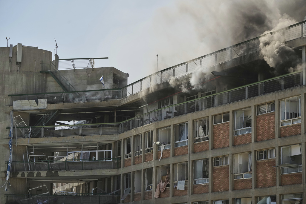 Smokes raises from a building of the Soroka hospital complex after it was hit by a missile