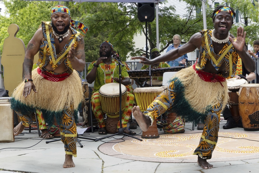 Members of the Akwaaba Ensemble Nii Osenda, left, and Samuel Marquaye dance during a Juneteenth celebration