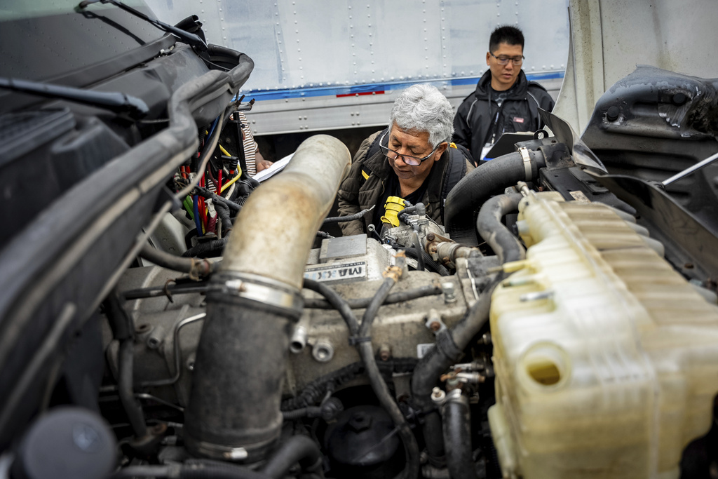 A student studies a truck engine at the Driving Academy in Linden, N.J., where students prepare to obtain a Commercial Driver’s License (CDL) with multilingual instructors
