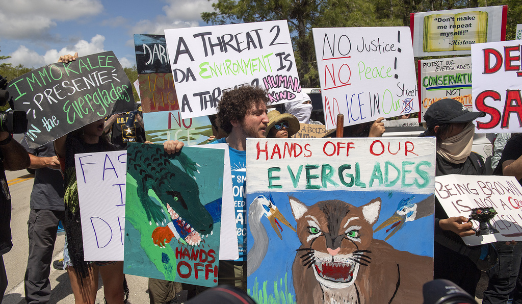 Protesters march outside the Dade-Collier Training and Transition Airport
