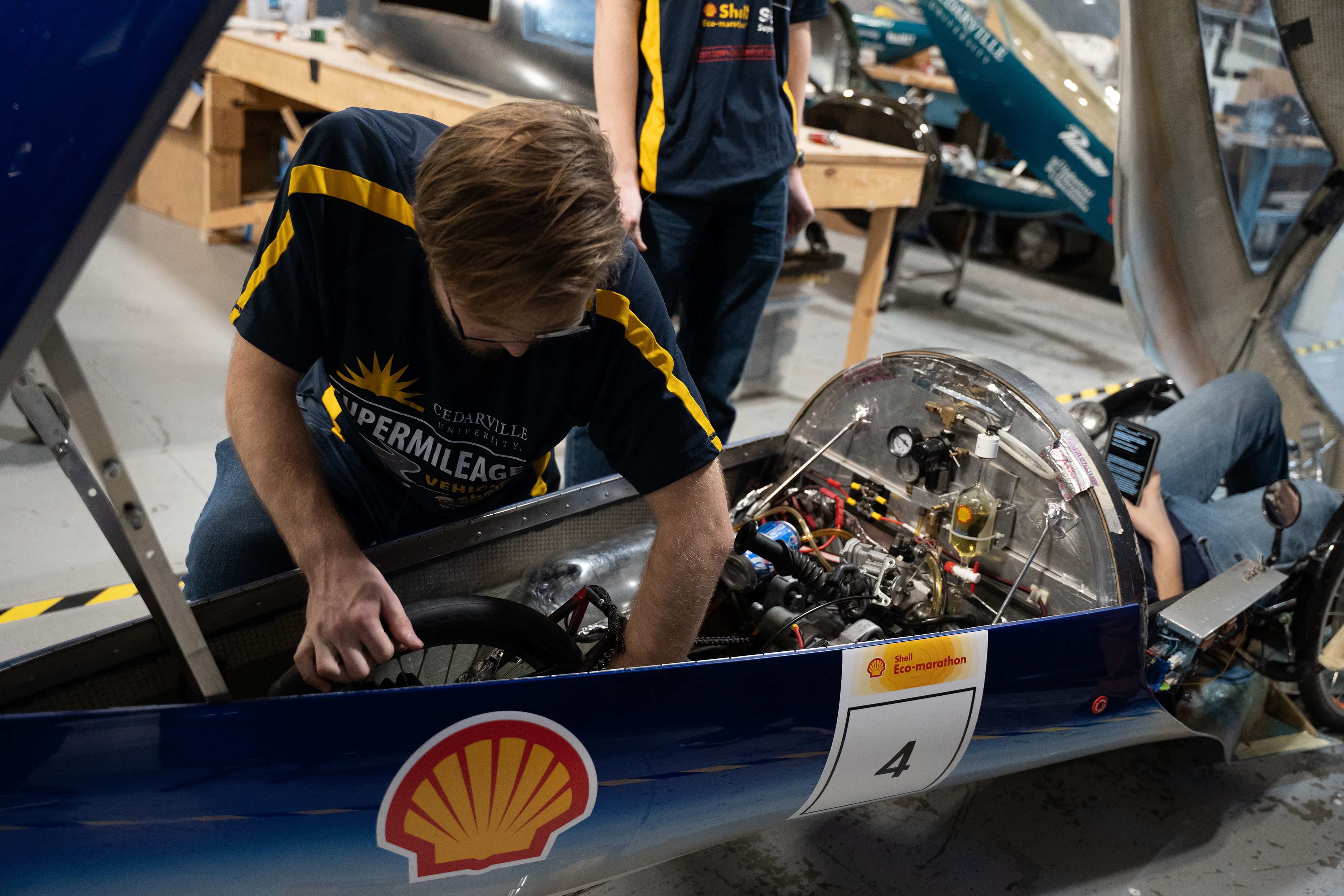A Cedarville engineering student makes sure its car is in top working order prior to the Shell EcoMarathon this year
