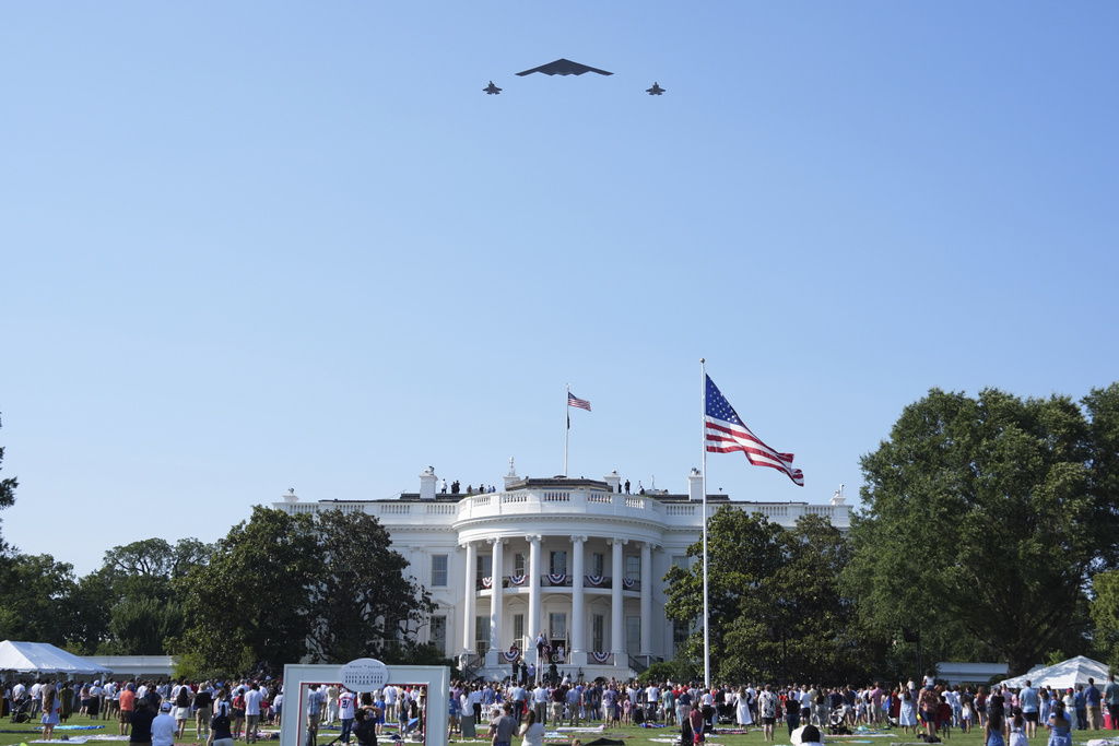 A B-2 bomber and two F-22 fighters conduct a flyover during a Fourth of July celebration at the White House