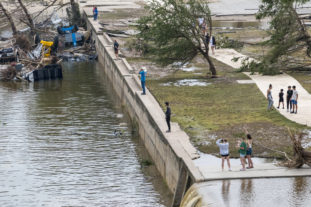 People along the banks of the Guadalupe River in Louise Hays Park in Kerrville, Texas