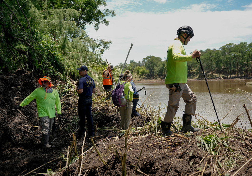 Eric Herr, a volunteer with Search and Support San Antonio, does search work on the banks of the Guadalupe River in Ingram, Texas