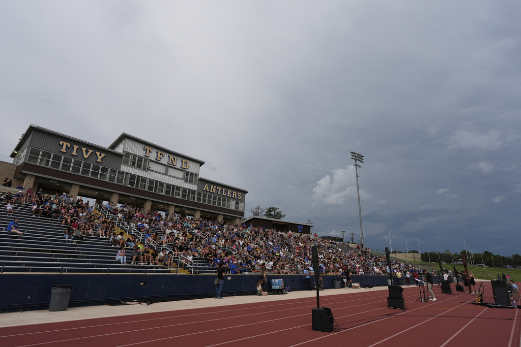 Clouds move in during a vigil for flooding victims at Tivy Antler Stadium in Kerrville, Texas