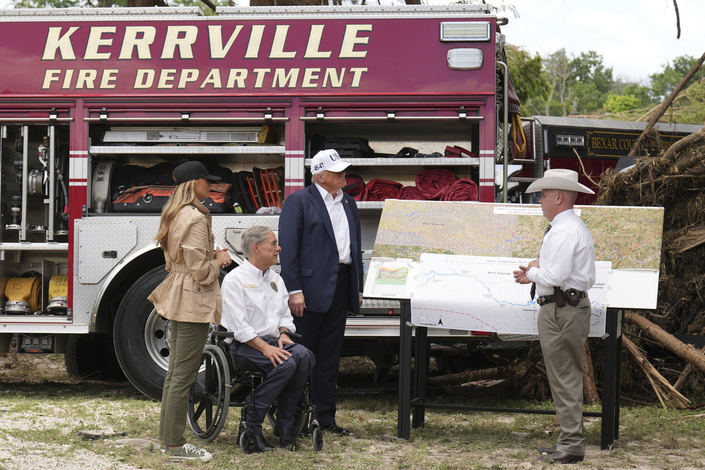 First lady Melania Trump, from left, Texas Gov. Greg Abbott and President Donald Trump are briefed on flood damage in Kerrville, Texas