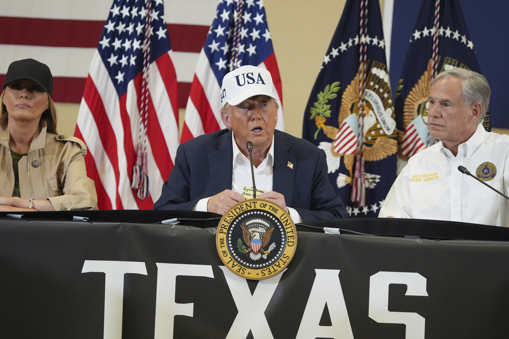 President Donald Trump speaks as first lady Melania Trump, left, and Texas Gov. Greg Abbott listen during a roundtable discussion with first responders and local officials at Hill Country Youth Event Center in Kerrville, Texas