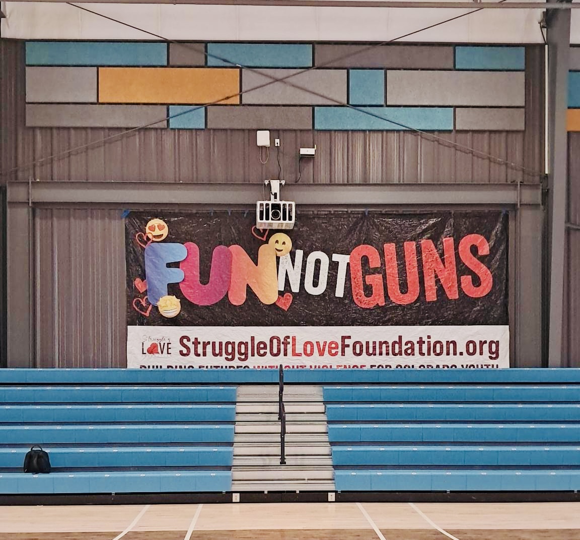 A Fun, Not Guns program poster hangs in a gymnasium in Denver