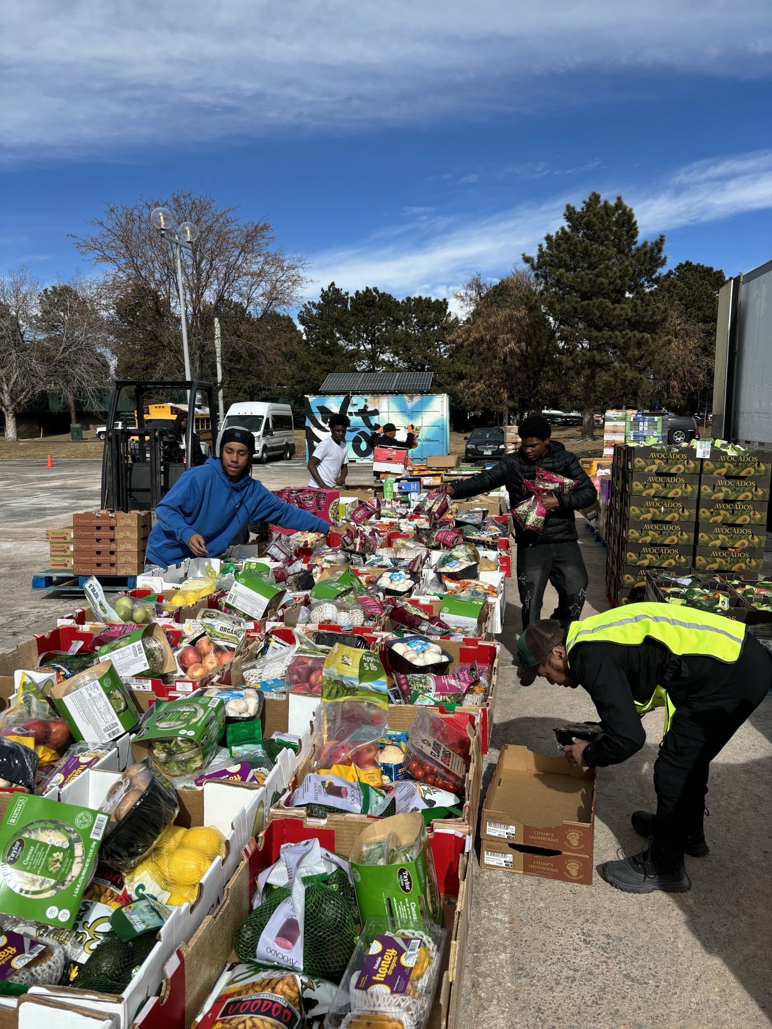 Three volunteers package food for the Struggle of Love Foundation’s Sacks of Love food pantry.