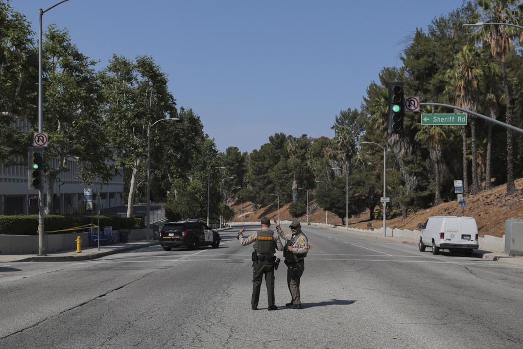 Sheriffs deputies monitor a street closure near the site of an explosion at the LA County Sheriff