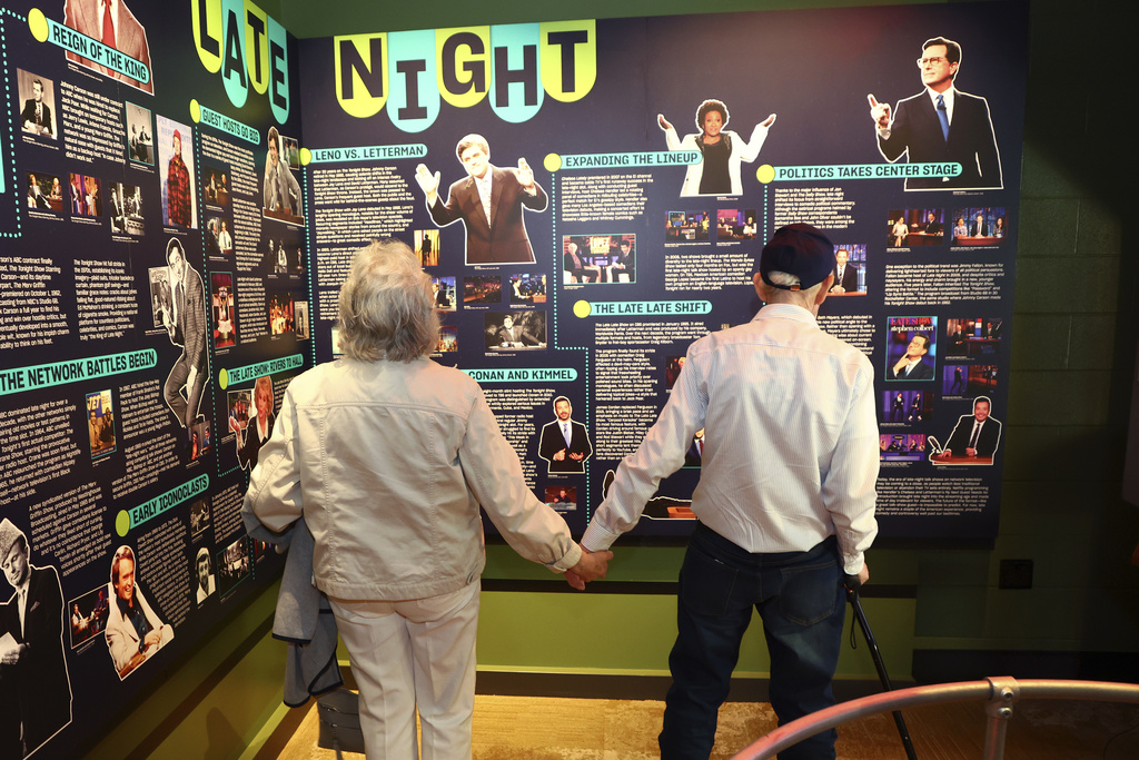 Mario and Gail Cirasunda, of Orchard Park, N.Y., look at exhibits from past and current comedy stars on display during a Memory Cafe event at the National Comedy Center in Jamestown, N.Y.