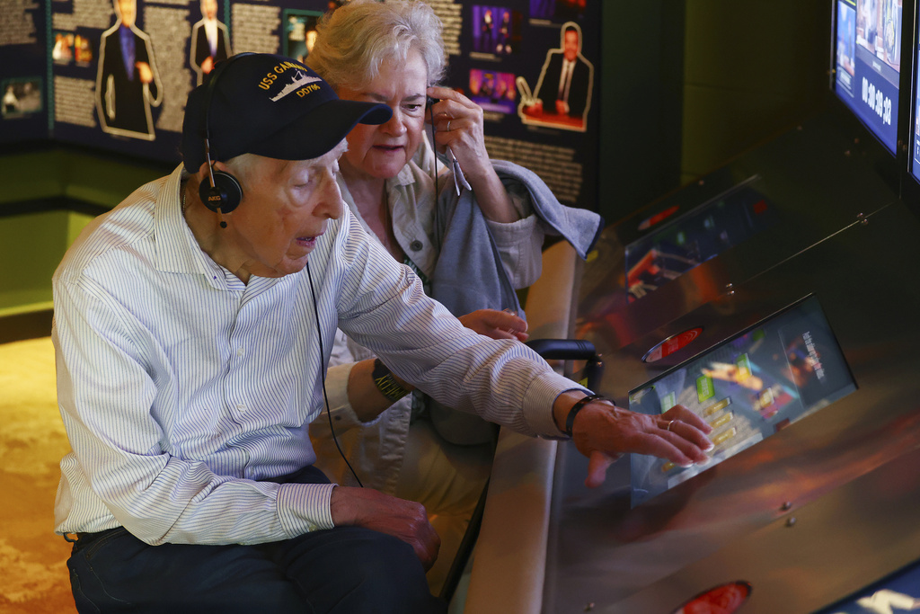 Mario and Gail Cirasunda, of Orchard Park, N.Y., interact with one of the museum