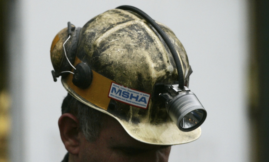 A miner gathers his thought before taking part in a rescue mission