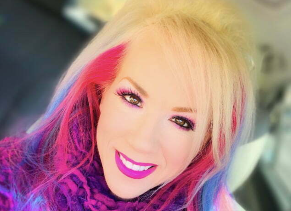 Woman smiling with pink and blonde hair