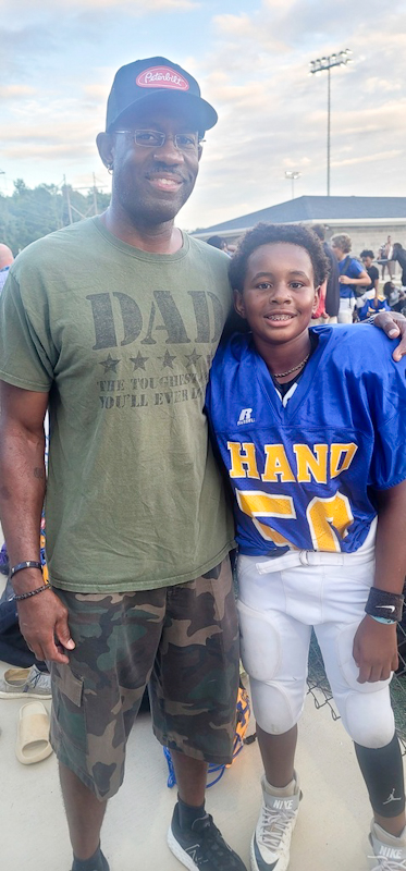 Clarence Carr and his son Jaysen at his middle school football game in Columbia, S.C.