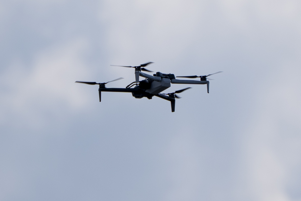 Law enforcement drone hovers before President Donald Trump departs in his motorcade from the Trump International Golf Club in West Palm Beach, Fla. 