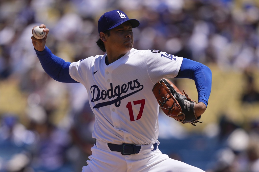 Dodgers starting pitcher Shohei Ohtani throws to the plate 