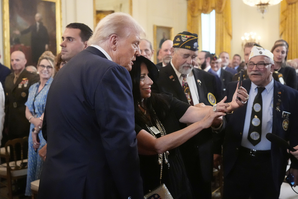 President Donald Trump, left, takes a selfie