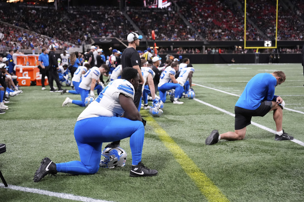 Detroit Lions players take a knee after safety Morice Norris was injured against the Atlanta Falcons during the second half of an NFL preseason football game