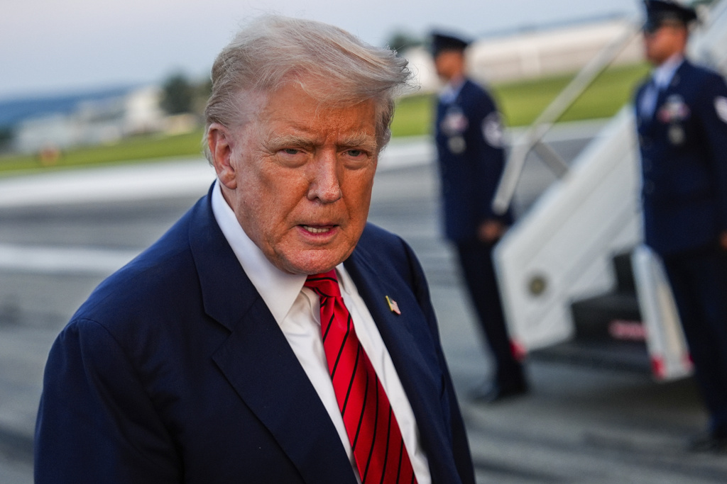 President Donald Trump speaks with reporters before boarding Air Force One