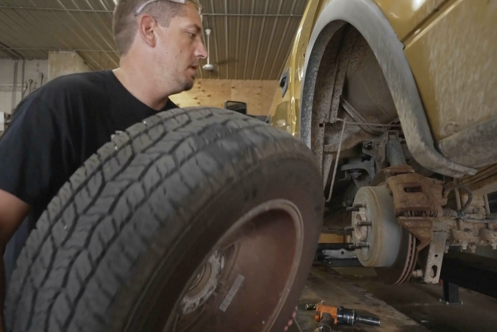 Mechanic Chad Volk works on a vehicle in his shop in Lake Crystal, Minn.