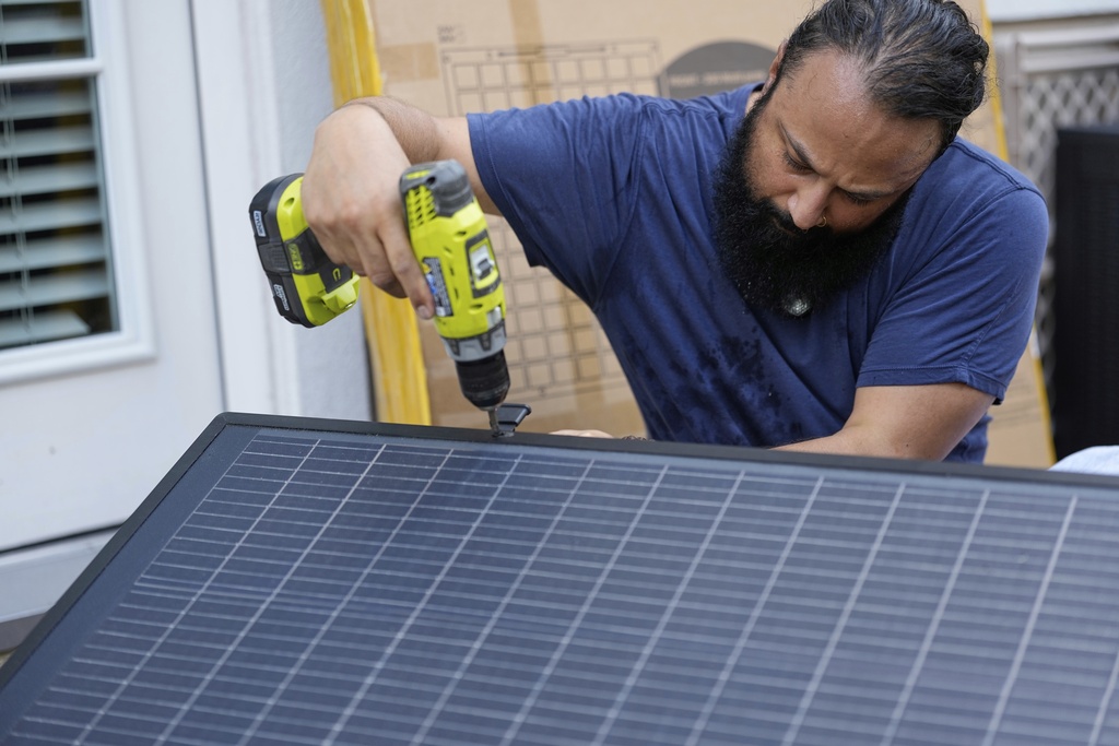 Bhavin Misra assembles a Craftstrom Solar plug-in kit at his home in Houston