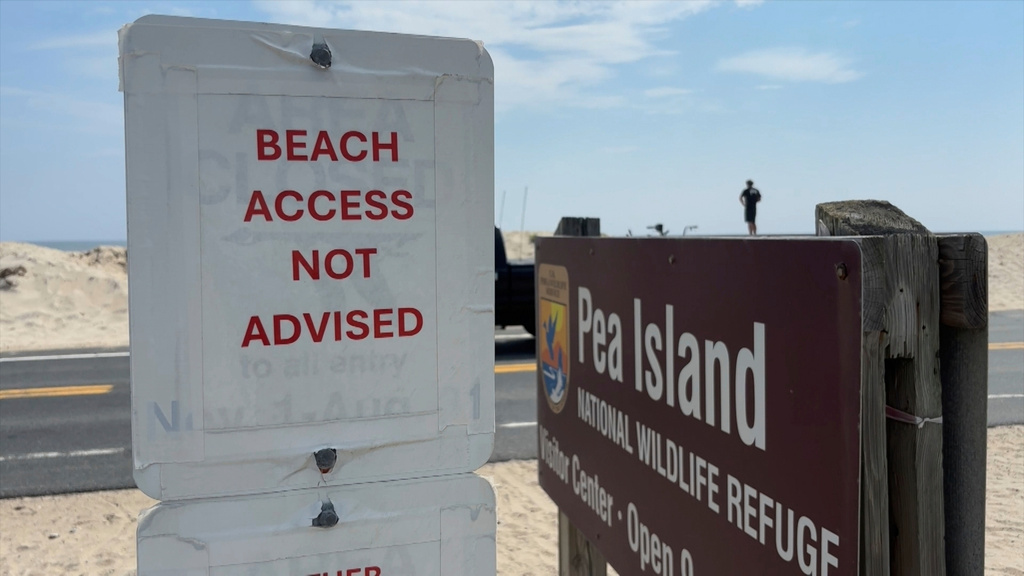 Sign warning against beach access is posted in Dare County, N.C.