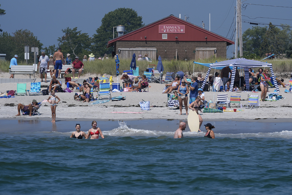 Visitors enjoy the summer weather not far from recent sightings of white sharks in Scarborough, Maine